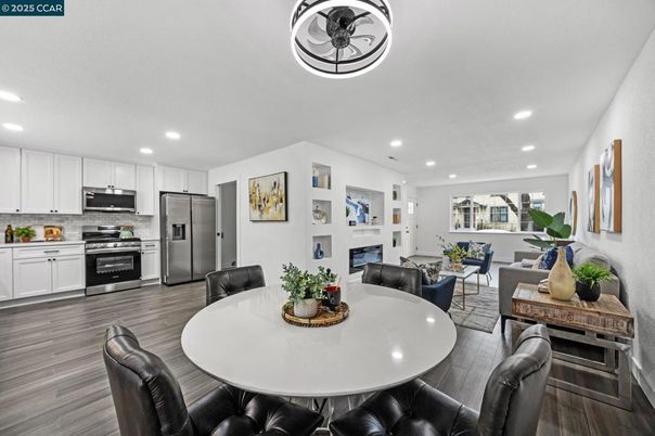 Dining room, Fireplace, Interior, Kitchen, Living room, Recessed Lighting, Stainless Steel Appliances, Wood Texture Flooring