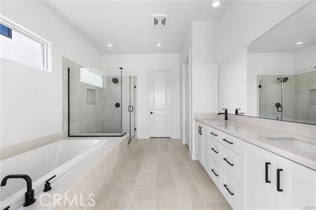 Bathroom, Dual Sink Vanities, Glass Shower, Interior, Recessed Lighting, Wood Texture Flooring