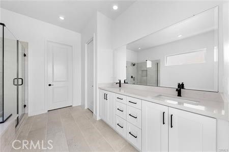 Bathroom, Dual Sink Vanities, Glass Shower, Interior, Recessed Lighting, Wood Texture Flooring