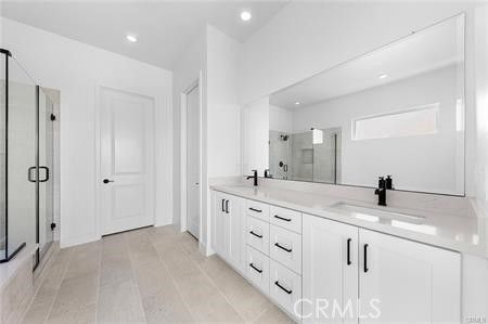 Bathroom, Dual Sink Vanities, Glass Shower, Interior, Recessed Lighting, Wood Texture Flooring