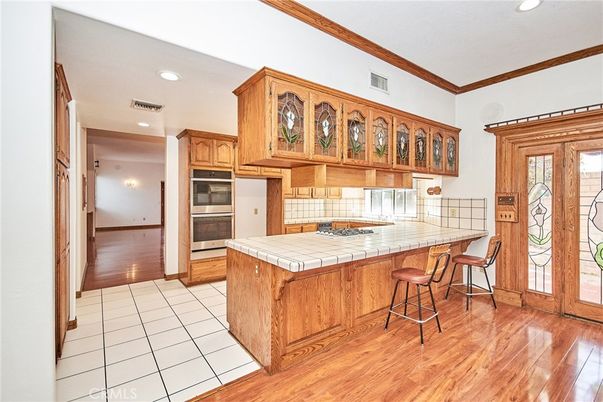 Interior, Kitchen, Recessed Lighting, Tile Countertops, Wood Texture Flooring