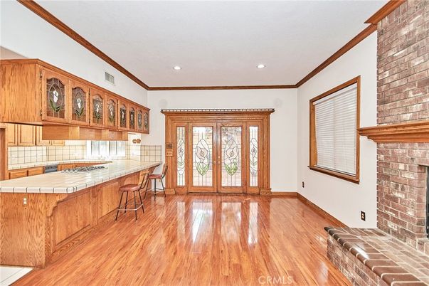 Fireplace, Interior, Kitchen, Recessed Lighting, Stone Walls, Tile Countertops, Wood Texture Flooring