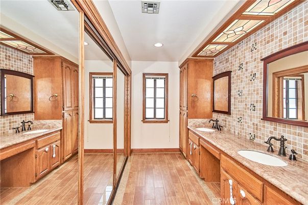 Bathroom, Dual Sink Vanities, Interior, Recessed Lighting, Stone Walls, Wood Texture Flooring