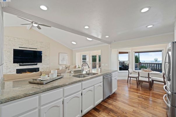 Dining room, Fireplace, Interior, Kitchen, Living room, Recessed Lighting, Stone Walls, Wood Texture Flooring