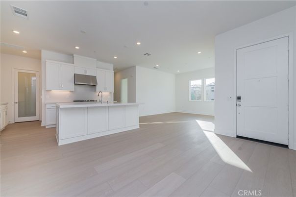 Empty room, Interior, Kitchen, Recessed Lighting, Stainless Steel Appliances, Wood Texture Flooring