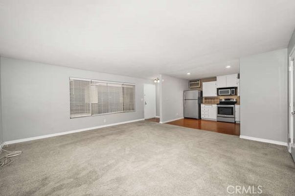 Empty room, Interior, Kitchen, Recessed Lighting, Stainless Steel Appliances, Wood Texture Flooring