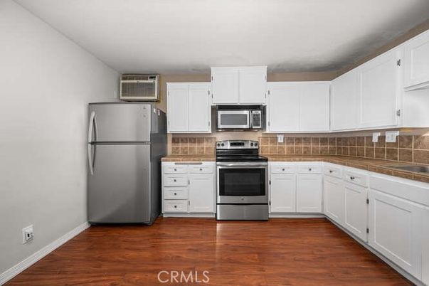 Interior, Kitchen, Stainless Steel Appliances, Tile Countertops, Wood Texture Flooring