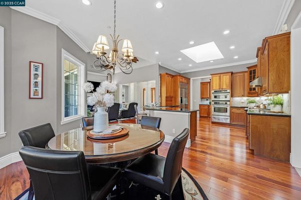 Chandelier, Dining room, Interior, Kitchen, Recessed Lighting, Stainless Steel Appliances, Wood Texture Flooring