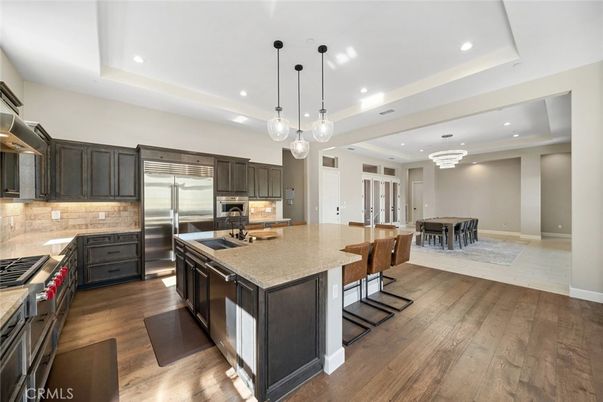 Chandelier, Dining room, Interior, Kitchen, Pendant Lights, Recessed Lighting, Stainless Steel Appliances, Wood Texture Flooring