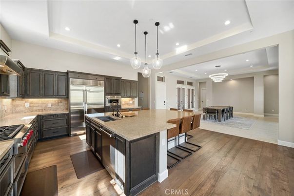 Chandelier, Dining room, Interior, Kitchen, Pendant Lights, Recessed Lighting, Stainless Steel Appliances, Wood Texture Flooring
