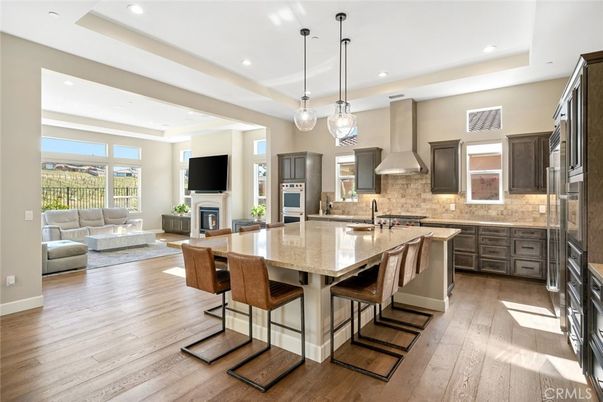 Dining room, Fireplace, Interior, Kitchen, Living room, Pendant Lights, Recessed Lighting, Stainless Steel Appliances, Wood Texture Flooring