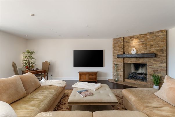 Dining room, Fireplace, Interior, Living room, Recessed Lighting, Stone Walls, Wood Texture Flooring