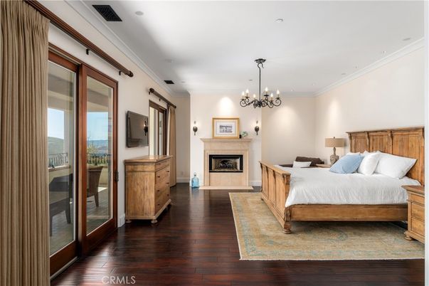 Bedroom, Chandelier, Fireplace, Interior, Recessed Lighting, Wood Texture Flooring