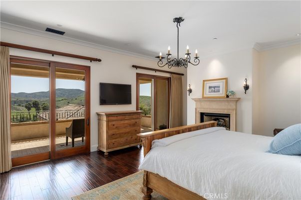Bedroom, Chandelier, Fireplace, Interior, Recessed Lighting, Wood Texture Flooring
