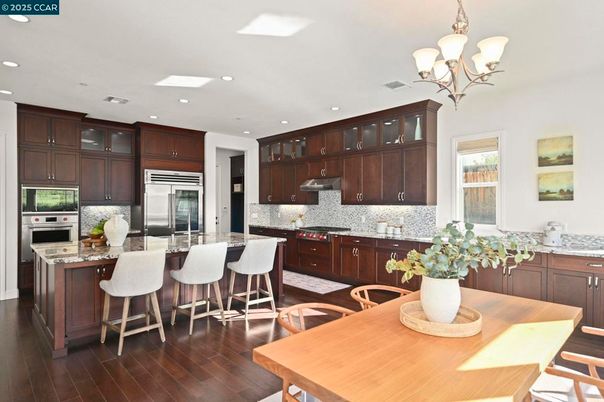 Chandelier, Dining room, Interior, Kitchen, Recessed Lighting, Stainless Steel Appliances, Wood Texture Flooring