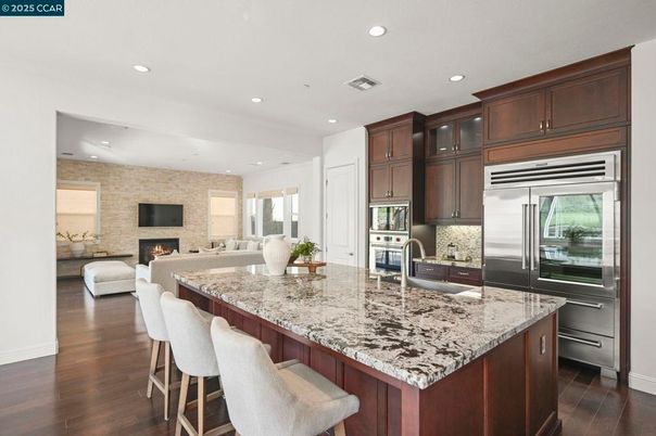 Fireplace, Interior, Kitchen, Living room, Recessed Lighting, Stainless Steel Appliances, Stone Walls, Wood Texture Flooring