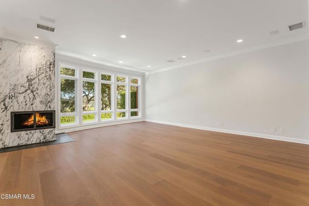 Empty room, Fireplace, Interior, Marble Walls, Recessed Lighting, Wood Texture Flooring