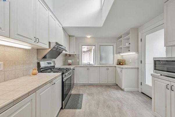 Interior, Kitchen, Stainless Steel Appliances, Tile Countertops, Wood Texture Flooring