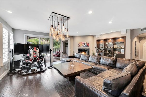 Fireplace, Fitness Equipment, Interior, Living room, Pendant Lights, Recessed Lighting, Wood Texture Flooring
