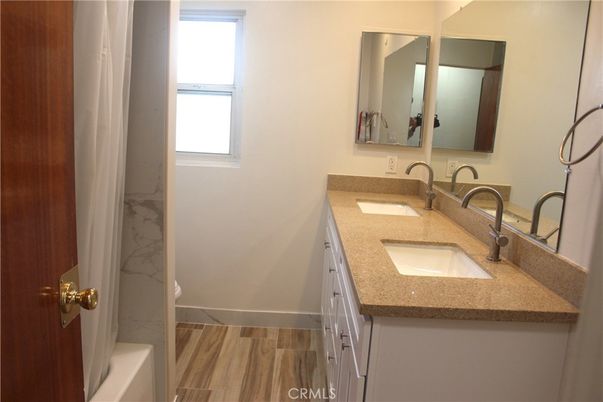 Bathroom, Dual Sink Vanities, Interior, Marble Walls, Wood Texture Flooring