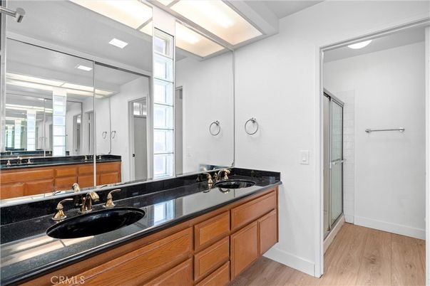 Bathroom, Dual Sink Vanities, Glass Shower, Interior, Recessed Lighting, Wood Texture Flooring