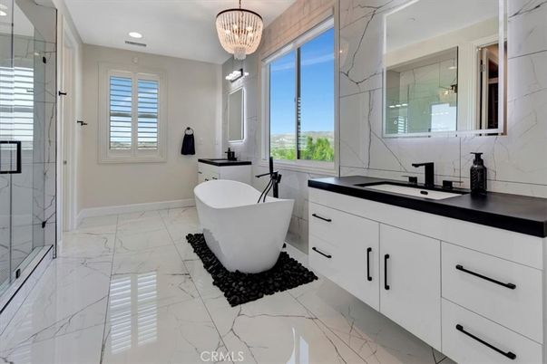 Bathroom, Chandelier, Dual Sink Vanities, Free Standing Baths, Glass Shower, Interior, Marble, Marble Walls, Recessed Lighting
