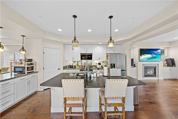 Fireplace, Interior, Kitchen, Pendant Lights, Recessed Lighting, Stainless Steel Appliances, Wood Texture Flooring