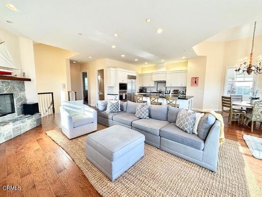 Chandelier, Dining room, Fireplace, Interior, Kitchen, Living room, Recessed Lighting, Stainless Steel Appliances, Wood Texture Flooring