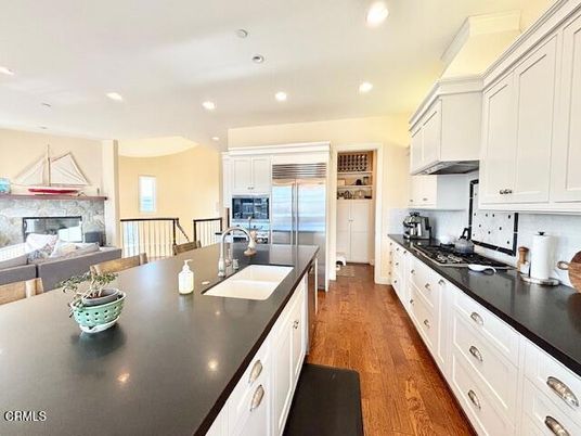 Fireplace, Interior, Kitchen, Recessed Lighting, Stainless Steel Appliances, Wood Texture Flooring