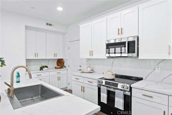 Interior, Kitchen, Marble Walls, Recessed Lighting, Stainless Steel Appliances