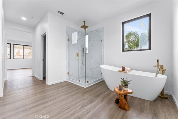Bathroom, Free Standing Baths, Glass Shower, Interior, Marble Walls, Recessed Lighting, Wood Texture Flooring