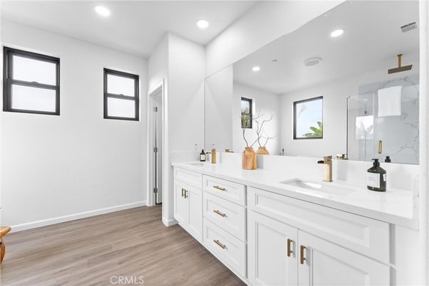 Bathroom, Dual Sink Vanities, Interior, Marble Walls, Recessed Lighting, Wood Texture Flooring