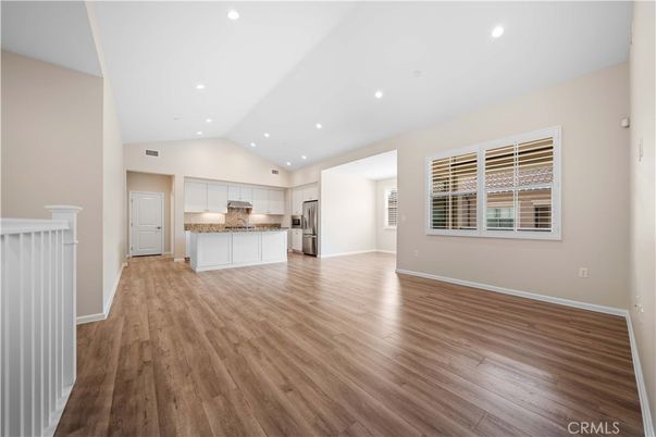 Empty room, Interior, Kitchen, Recessed Lighting, Stainless Steel Appliances, Wood Texture Flooring