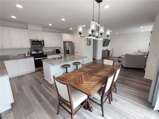 Chandelier, Dining room, Interior, Kitchen, Living room, Pendant Lights, Recessed Lighting, Stainless Steel Appliances, Wood Texture Flooring