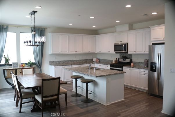 Chandelier, Dining room, Interior, Kitchen, Pendant Lights, Recessed Lighting, Stainless Steel Appliances, Wood Texture Flooring