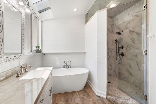 Bathroom, Free Standing Baths, Glass Shower, Interior, Marble Walls, Recessed Lighting, Wood Texture Flooring