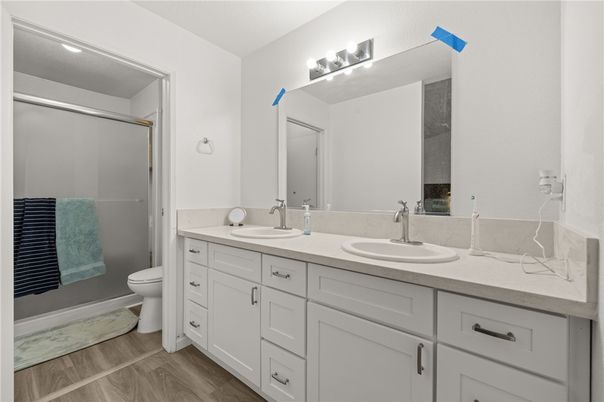 Bathroom, Dual Sink Vanities, Glass Shower, Interior, Recessed Lighting, Wood Texture Flooring