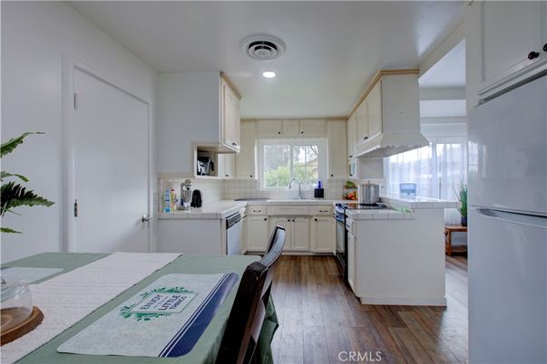 Interior, Kitchen, Recessed Lighting, Tile Countertops, Wood Texture Flooring