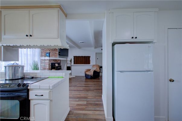 Fireplace, Interior, Kitchen, Tile Countertops, Wood Texture Flooring