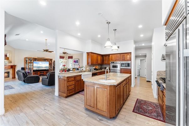 Fireplace, Interior, Kitchen, Living room, Pendant Lights, Recessed Lighting, Stainless Steel Appliances, Wood Texture Flooring