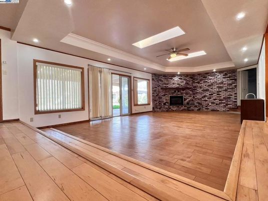 Empty room, Fireplace, Interior, Recessed Lighting, Stone Walls, Wood Texture Flooring
