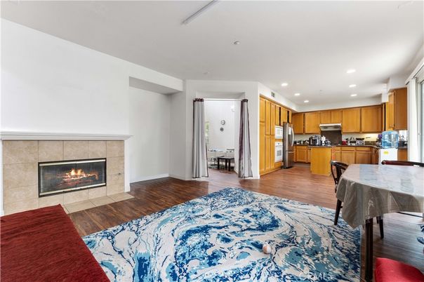 Dining room, Fireplace, Interior, Kitchen, Recessed Lighting, Stainless Steel Appliances, Wood Texture Flooring