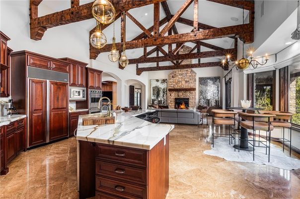 Chandelier, Dining room, Fireplace, Interior, Kitchen, Living room, Pendant Lights, Recessed Lighting, Stainless Steel Appliances, Wooden Beams