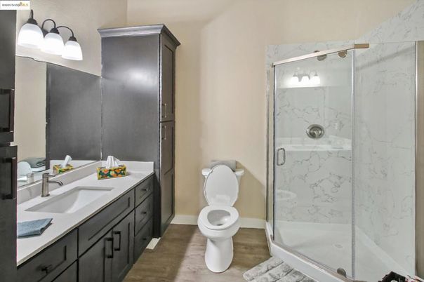 Bathroom, Dual Sink Vanities, Glass Shower, Interior, Marble Walls, Wood Texture Flooring