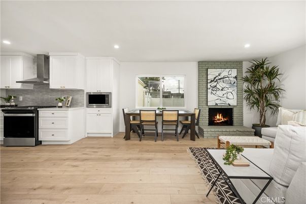 Dining room, Fireplace, Interior, Kitchen, Living room, Recessed Lighting, Stainless Steel Appliances, Stone Walls, Wood Texture Flooring