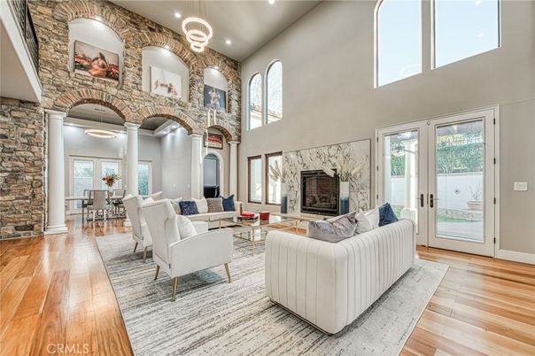 Dining room, Fireplace, Interior, Living room, Recessed Lighting, Stone Walls, Wood Texture Flooring