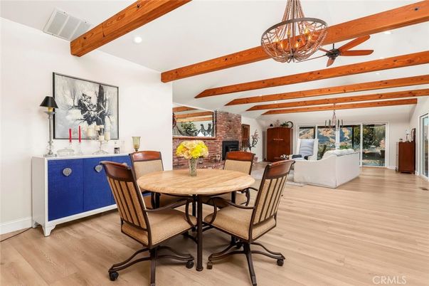 Chandelier, Dining room, Fireplace, Interior, Living room, Recessed Lighting, Stone Walls, Wooden Beams, Wood Texture Flooring