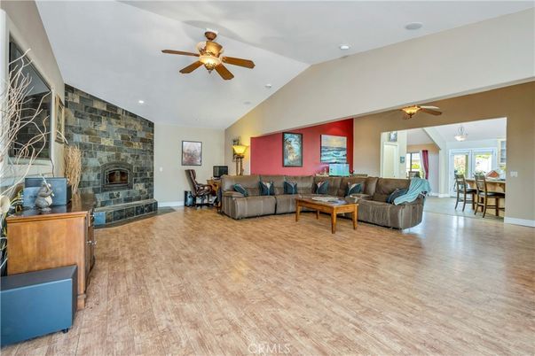 Dining room, Fireplace, Interior, Living room, Recessed Lighting, Stone Walls, Wood Texture Flooring