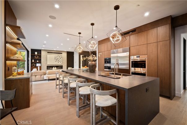 Fireplace, Interior, Kitchen, Living room, Pendant Lights, Recessed Lighting, Stainless Steel Appliances, Wood Texture Flooring