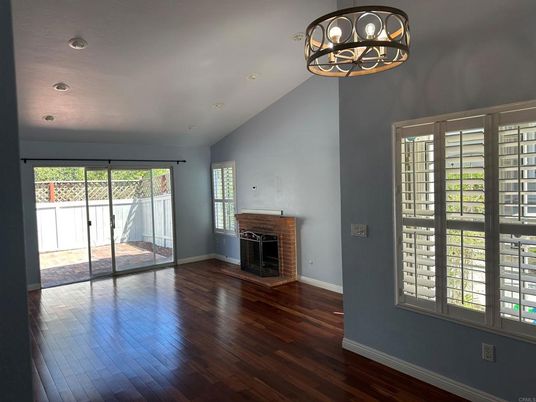 Chandelier, Empty room, Fireplace, Interior, Recessed Lighting, Wood Texture Flooring